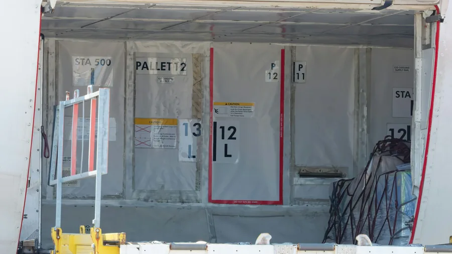 Air cargo containers inside an open aircraft hold